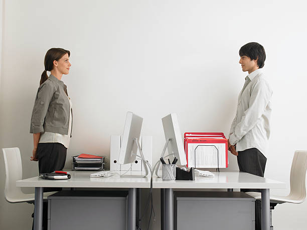 Seated hip stretch and neck side bend at desk